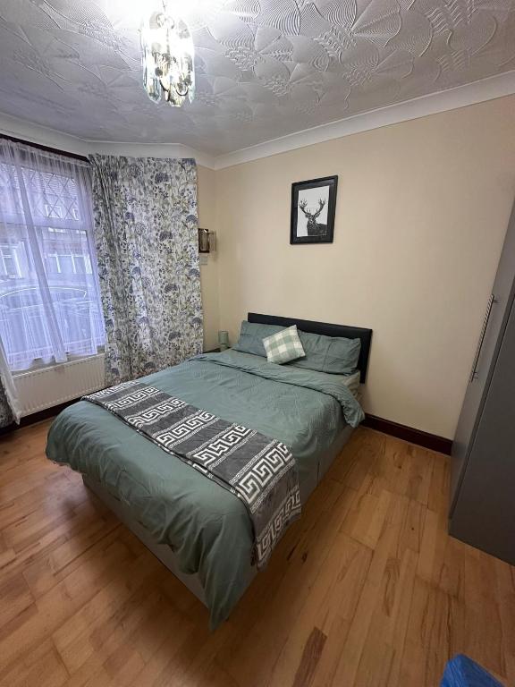 a bedroom with a bed and a chandelier at Double & Single rooms in Southall in Southall