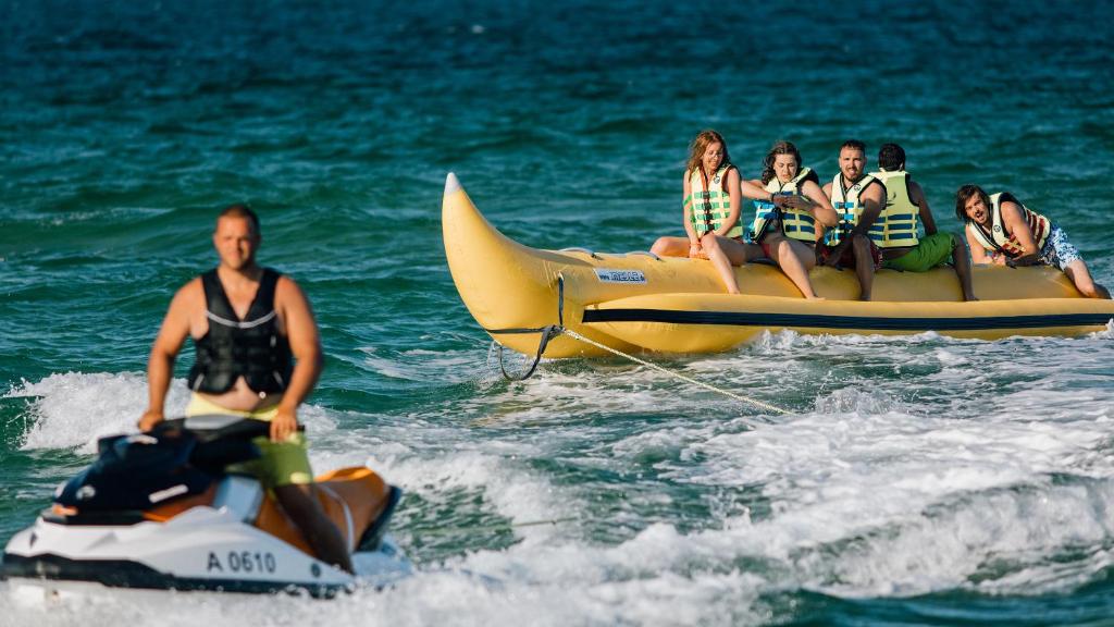 a group of people riding on a jet ski in the water at Green Life Apartments Sozopol in Sozopol