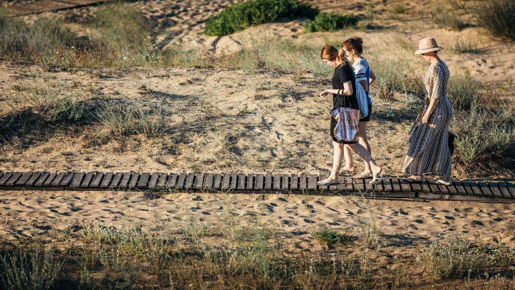 a group of three people walking on a train track at Green Life Apartments Sozopol in Sozopol