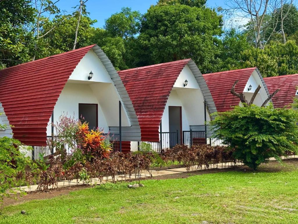 a house with a red roof at Eco Hotel Villas del Tortuguero in Cariari