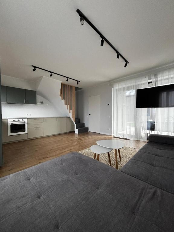 a living room with a couch and a table at Jūros namai in Palanga