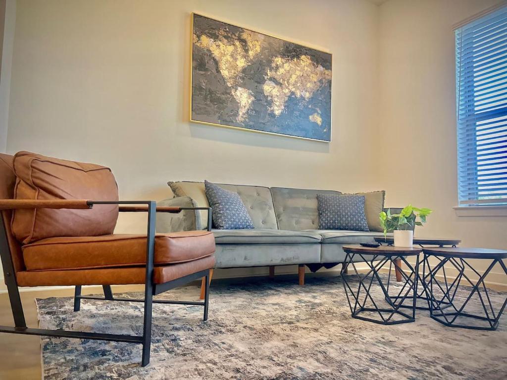 a living room with a couch and two tables at Modern A plus Location KINGbed pool gym in Sherman