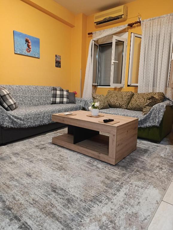 a living room with a couch and a coffee table at Πλάτανος Στούντιο ΙΙΙ PLATANOS STUDIO III in Mytilene