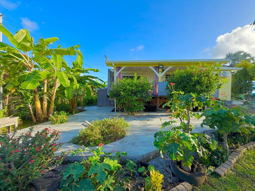 a house with a garden in front of it at Kanel' Kaz - Jacuzzi & Vue mer in Capesterre-Belle-Eau