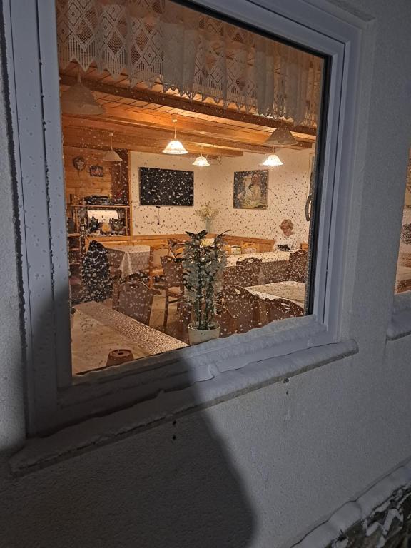 a view of a living room through a window at Gostišče Jelka, Hočko Pohorje in Pohorje