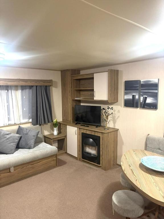 a living room with a couch and a table at Marton Mere 8 Berth Caravan in Blackpool