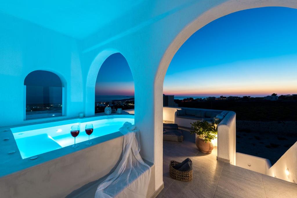 a villa with a swimming pool at night at Blanca Luxury Villa in Megalokhori