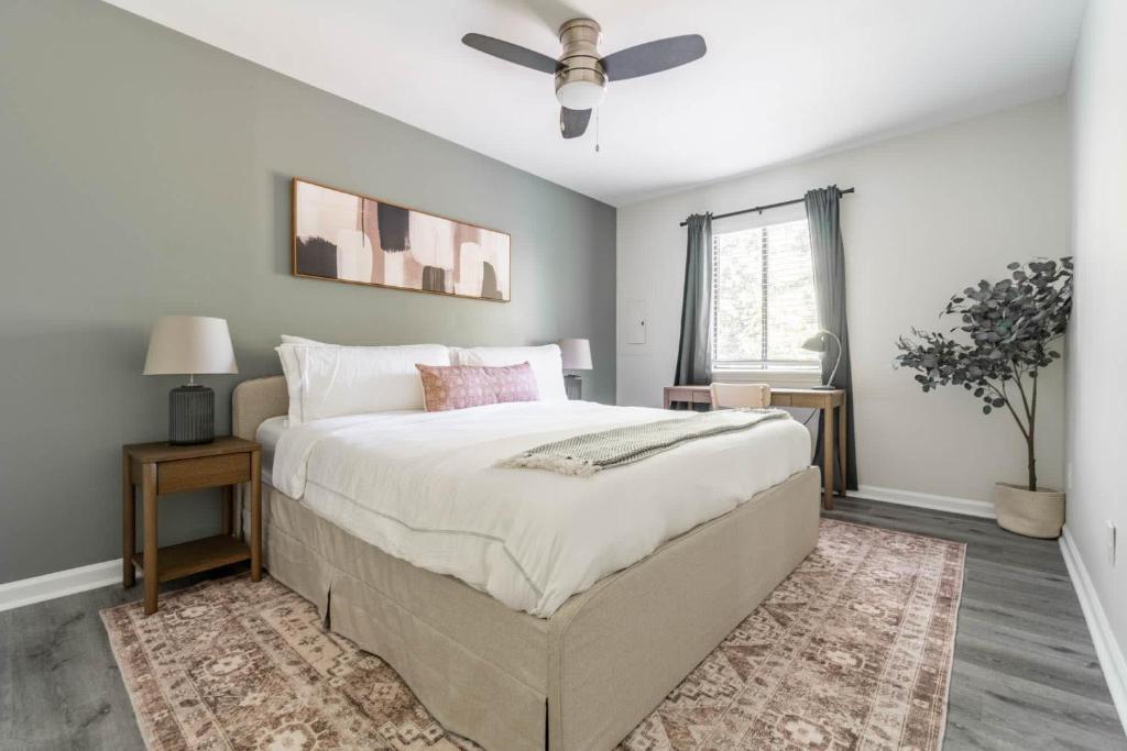 a bedroom with a large bed and a ceiling fan at The Vibe on Durham V 8782 in Durham