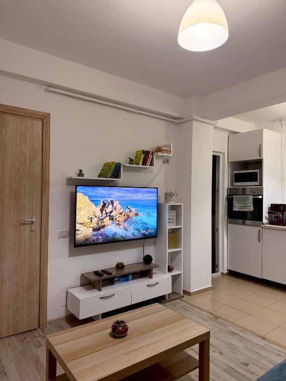a living room with a flat screen tv on a wall at Cozy 2Rooms in Popeşti-Leordeni