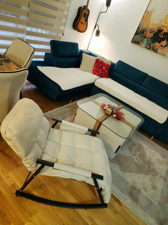 a living room with a couch and a chair at Apartman Smaragd in Loznica