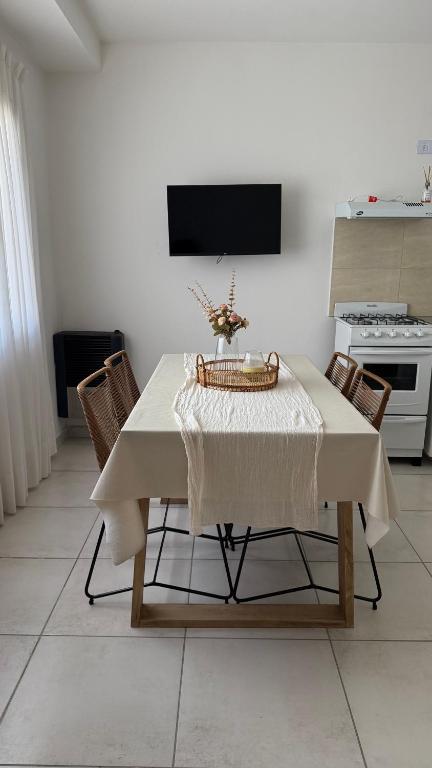 a table with a white table cloth on it in a kitchen at Amelie 2 in General Roca