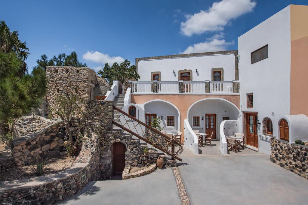 a villa with a staircase leading up to a house at Kokos Traditional Houses in Emporio