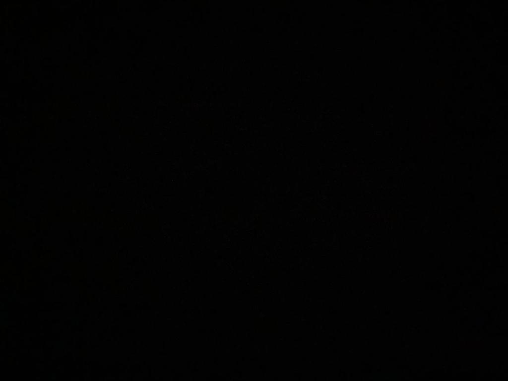 a dark room with a black background at Apartamento estiloso in Ubatuba