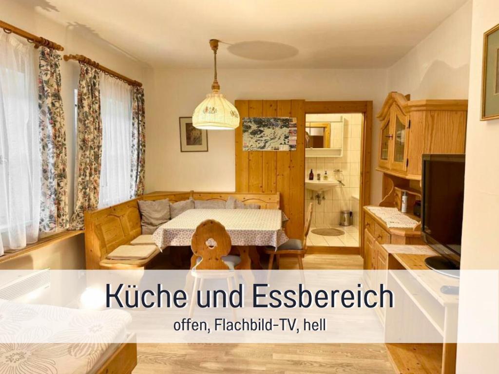 a living room with a bed and a kitchen at Waldrefugium nahe Gmunden - Ferienapartment für Familie und Hund in Pinsdorf