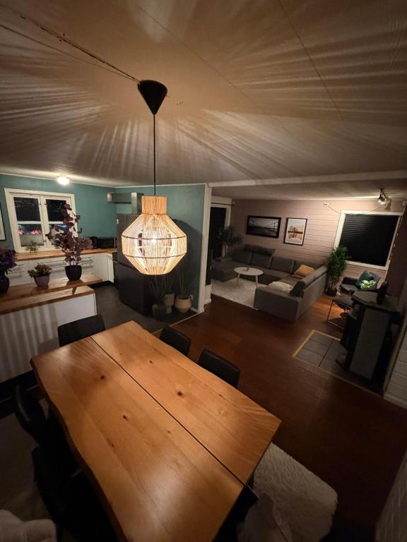 a living room with a wooden table and a couch at Recently renovated house in the heart of tromsdalen in Tromsø