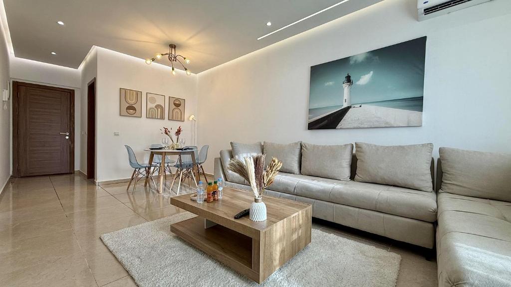 a living room with a couch and a table with a lighthouse at Vue imprenable sur mer in Tangier