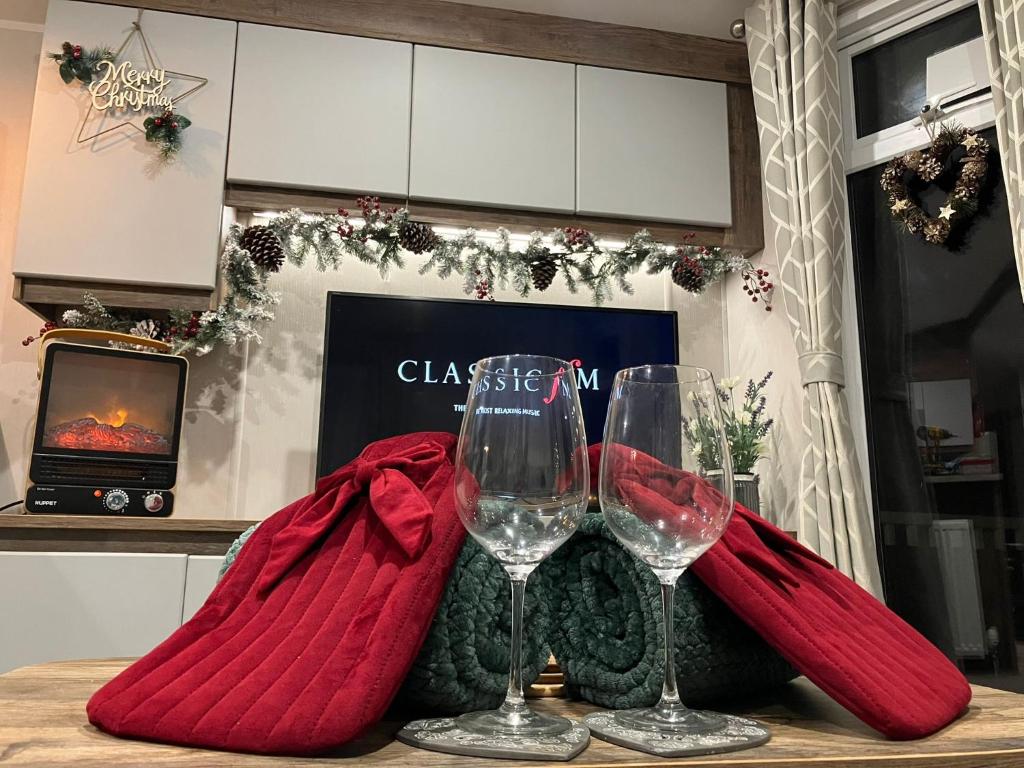 two wine glasses sitting on top of a table at Barmouthbay209 in Barmouth