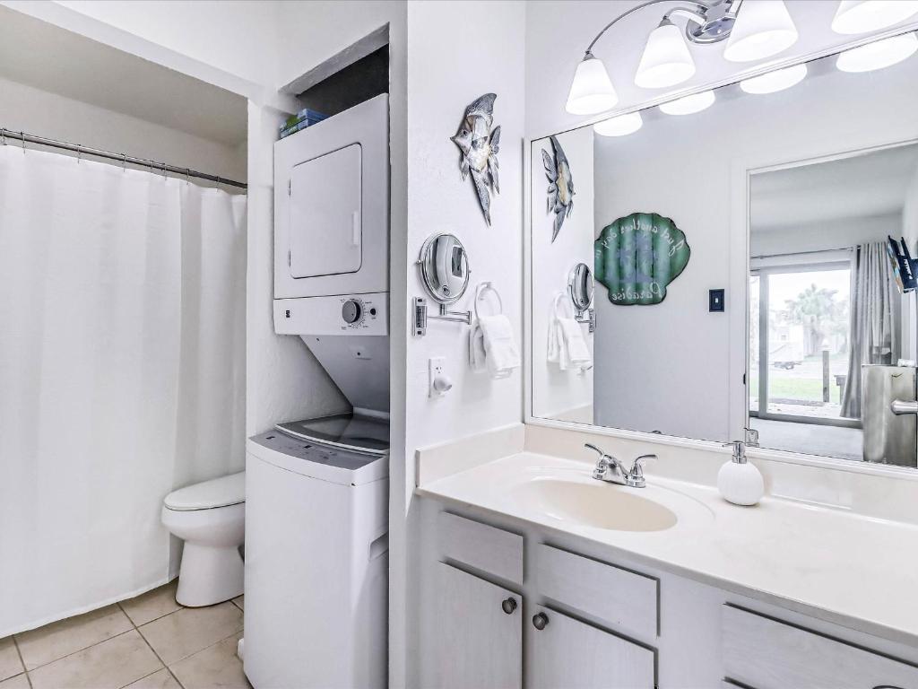a bathroom with a sink and a toilet and a mirror at Adventure House RRYC17 in Rockport