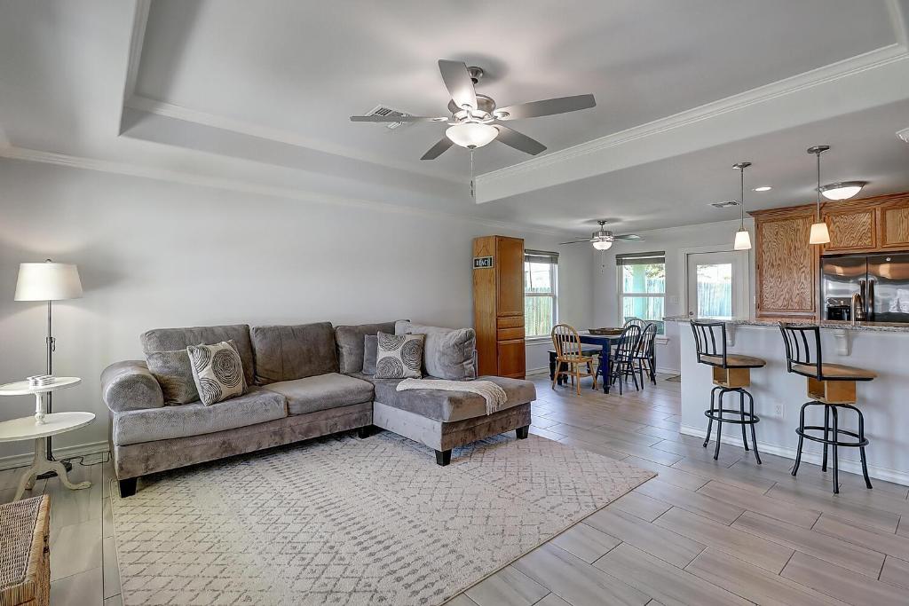 a living room with a couch and a table at A Wave From It All in Rockport