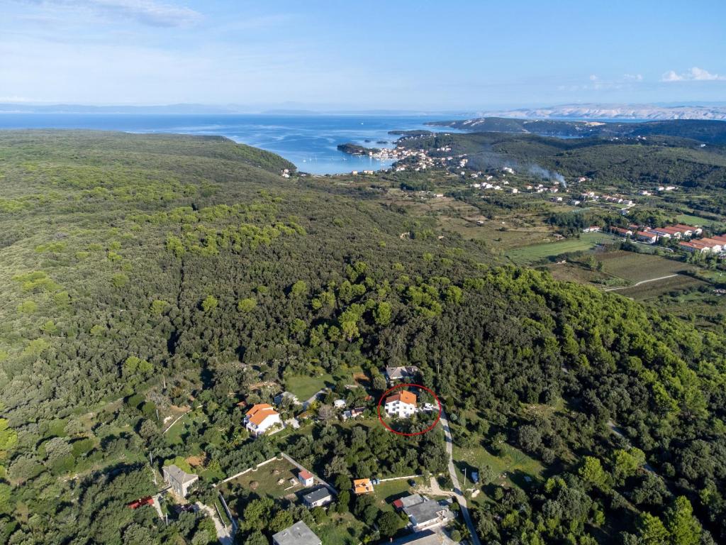 an aerial view of a house on a hill next to the ocean at Apartment Kampor 5014b in Kampor