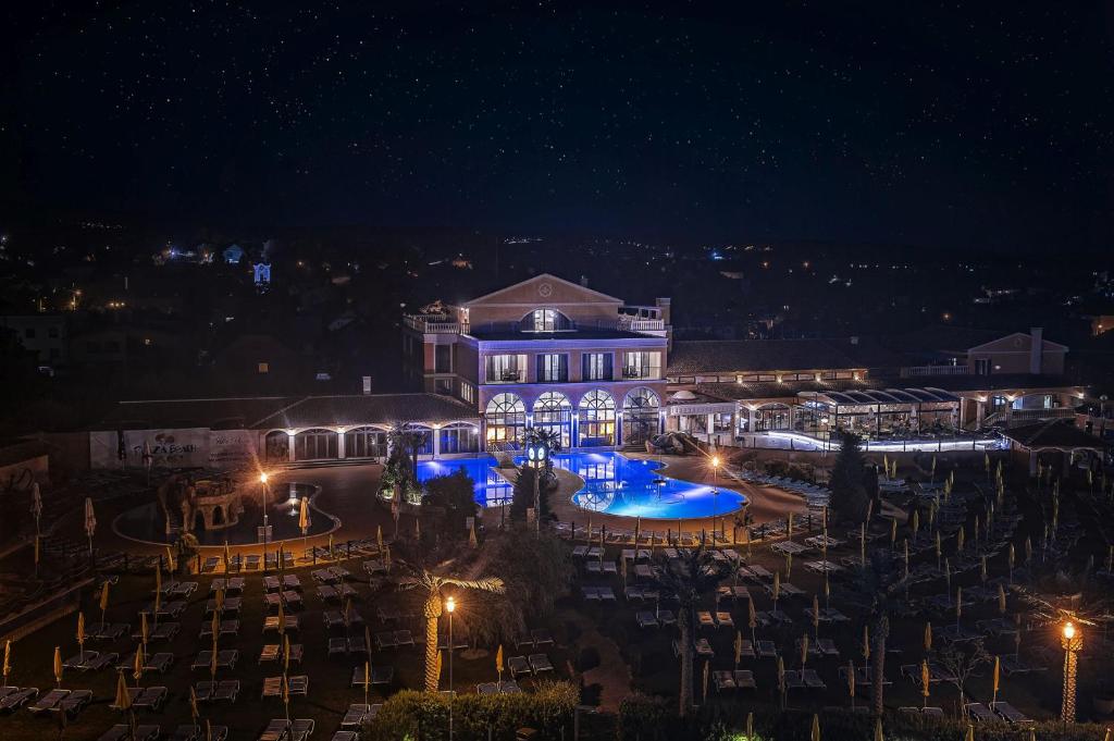 a night view of a building with lights at Villa Plaza Boutique Hotel & Spa in Prešov