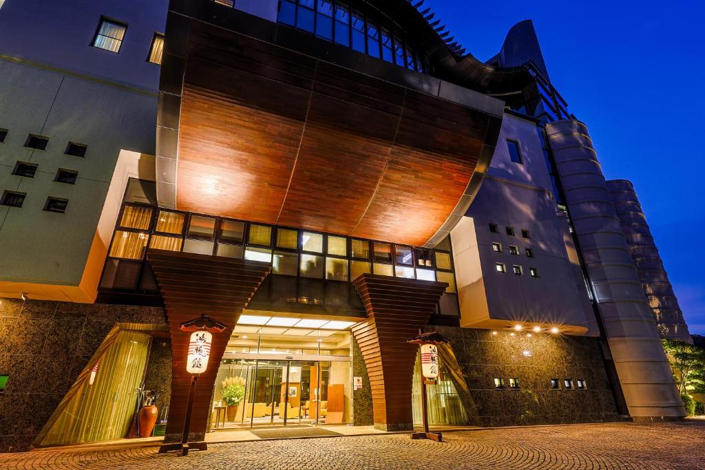 a building with two parking meters in front of it at Arima Onsen Gekkoen Korokan in Kobe