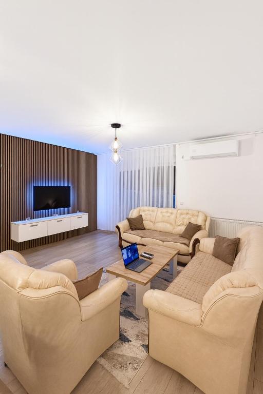 a living room with two couches and a tv at ORG Apartment - Ferizaj in Ferizaj