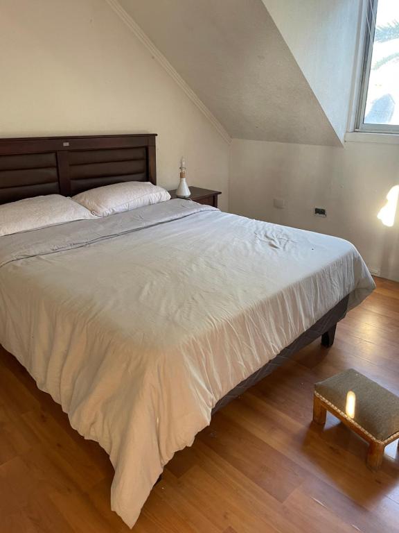 a bedroom with a large bed with a large window at habitaciones exclusivas in Curicó