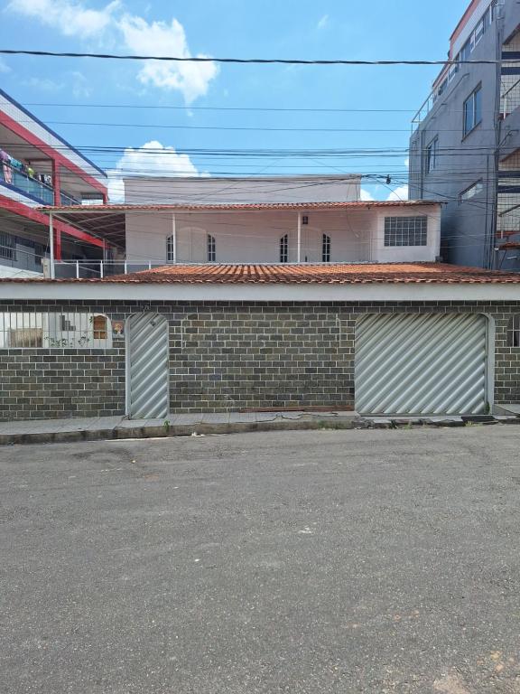 a brick wall with two garage doors in front of a building at RR 2 Pousada e Restaurante in Manaus