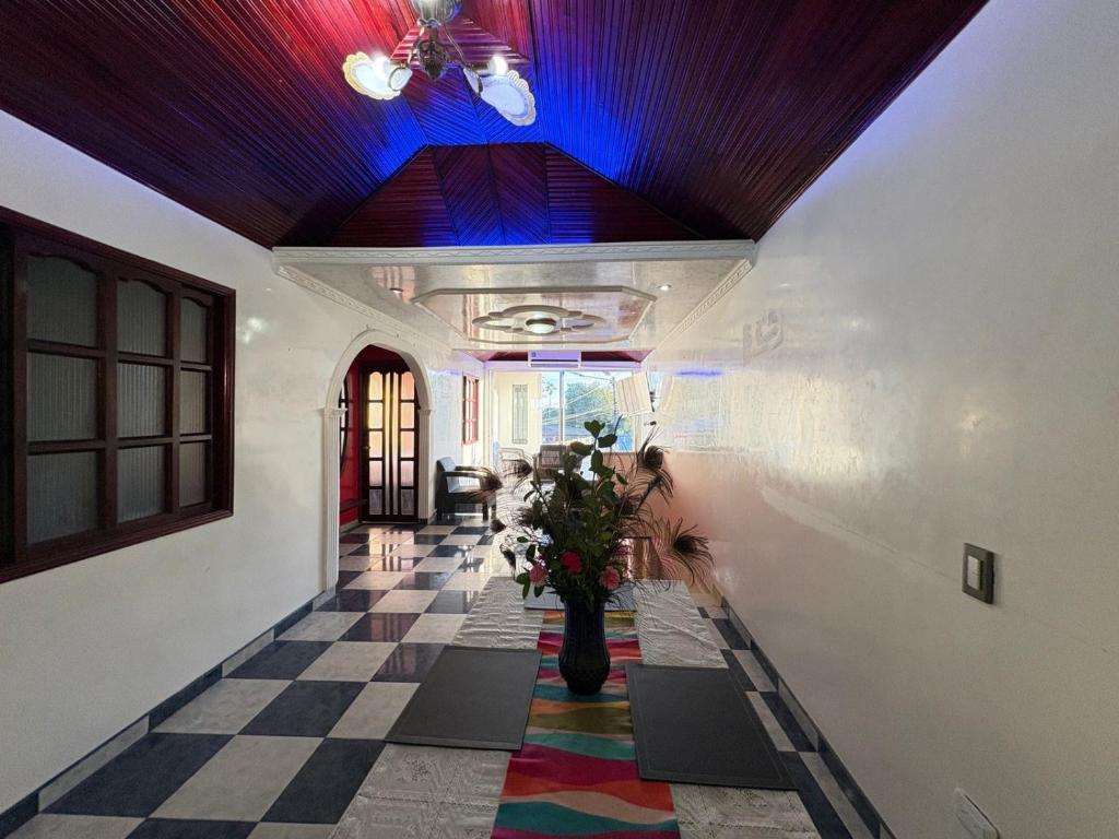 a hallway with a checkered floor and a blue ceiling at Apartamento Monterrey in Monterrey