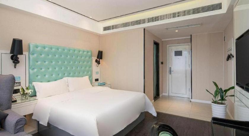 Ένα ή περισσότερα κρεβάτια σε δωμάτιο στο Xana Lite Nanchong Pengan Wuxing Garden Branch