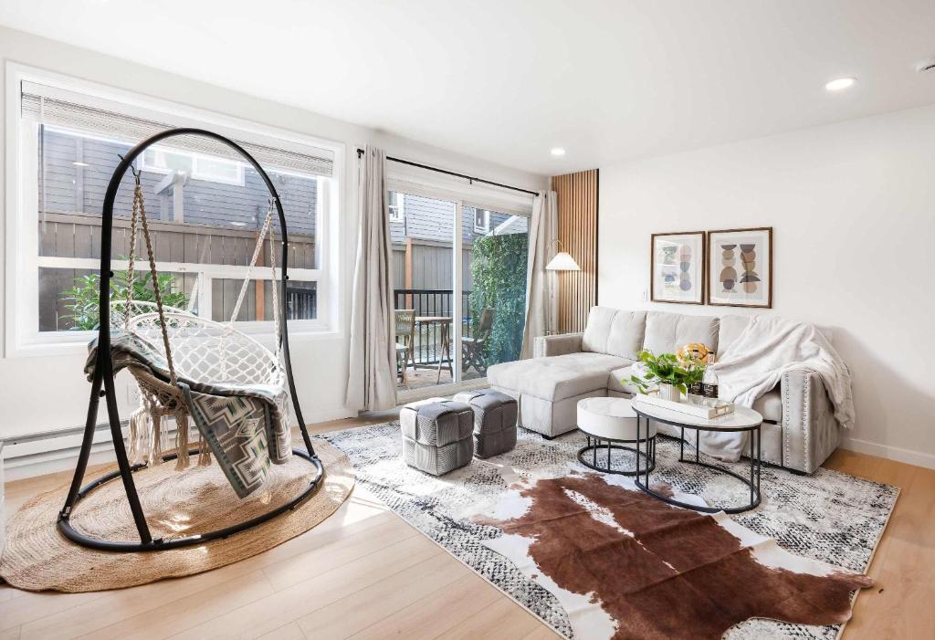 a living room with a couch and a table at Brand New 2BR Queen Anne Condo Designer's Taste in Seattle