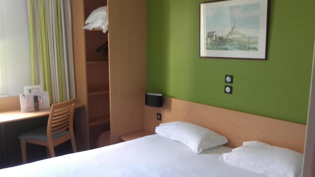Postel nebo postele na pokoji v ubytování Hôtel Vert