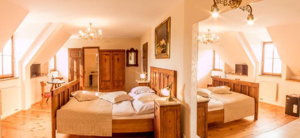 a bedroom with two beds in a room at Boutique hotel Pracháreň in Levoča