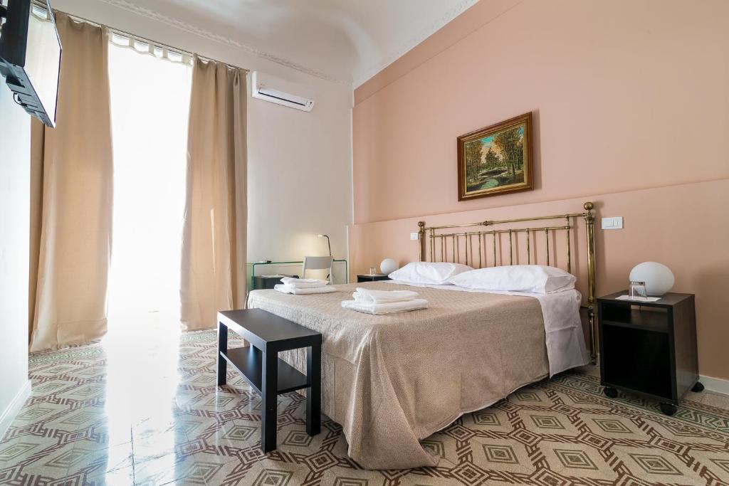 a hotel room with a bed and a table at Liberty Suites in Palermo