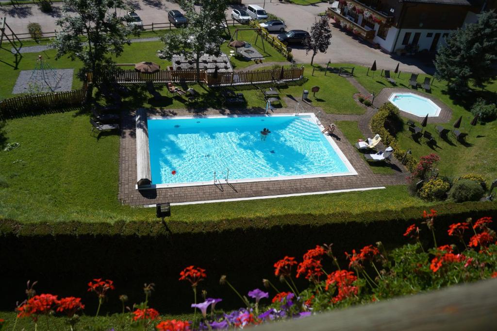 an overhead view of a swimming pool in a park at Landhaus St Georg inklusive Jokercard in Saalbach-Hinterglemm