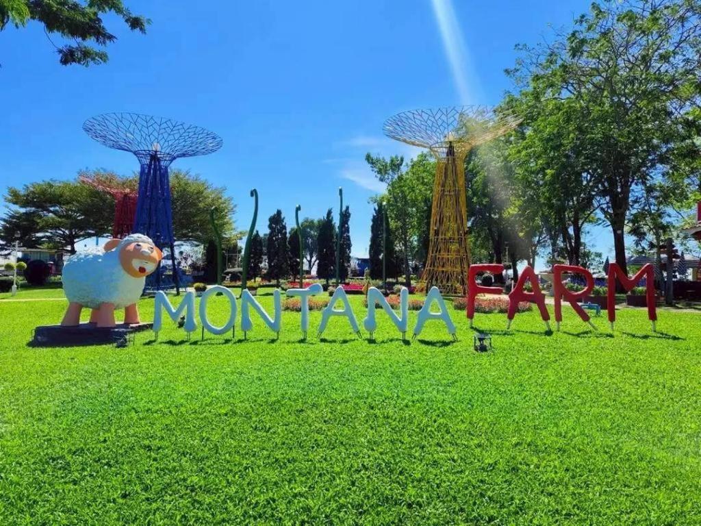 a park with a sign that says momoko at Montana Cotswolds Resort in Ban Kom