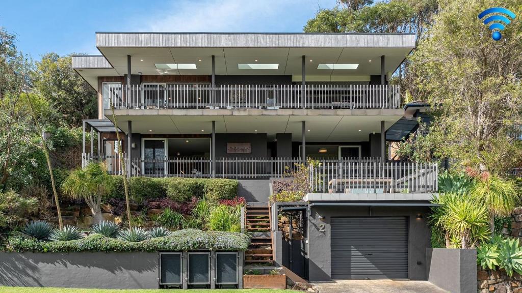 a large house with a balcony and a garage at Surf N Turf in Kiama