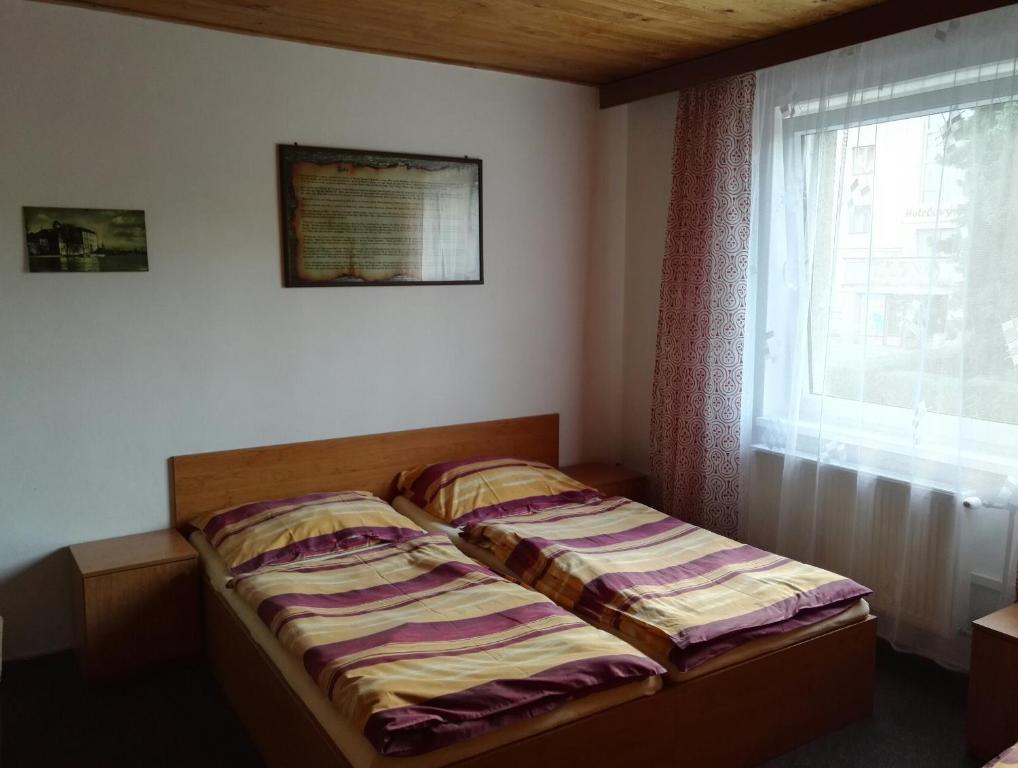 Postel nebo postele na pokoji v ubytování Penzion Tenis
