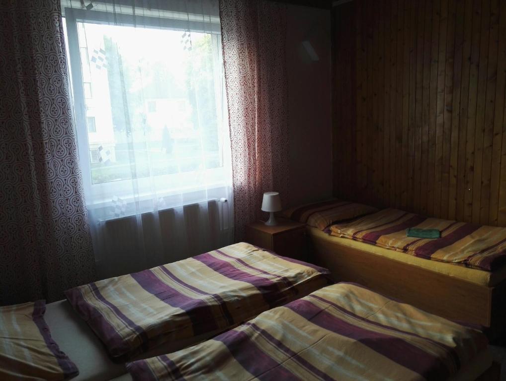 Postel nebo postele na pokoji v ubytování Penzion Tenis