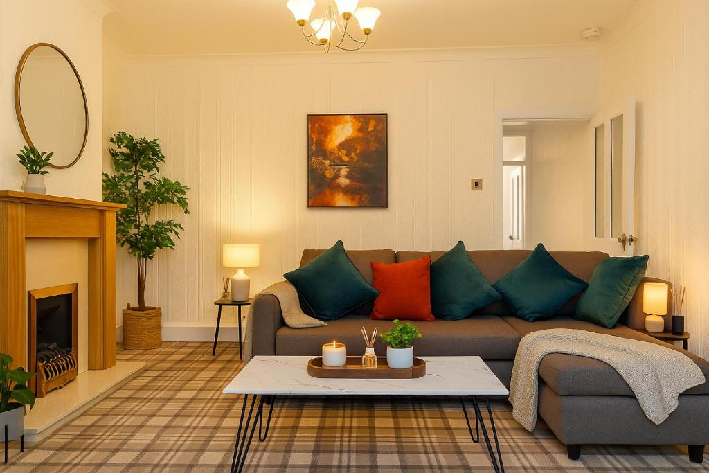 a living room with a couch and a table at Workington Haven - 3 Bed Home in Workington