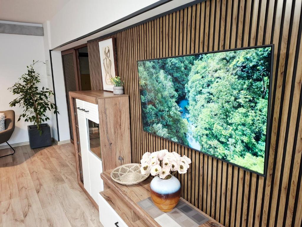 a living room with a large screen tv on a wall at Bulevard 11 in Brăila