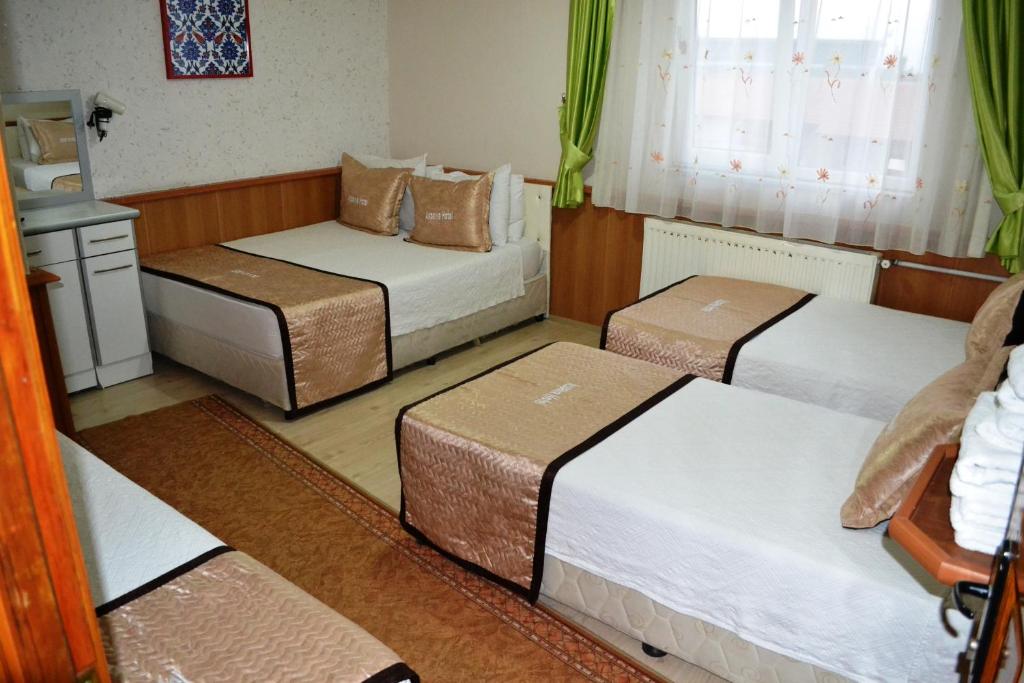 A bed or beds in a room at Aspawa Hotel