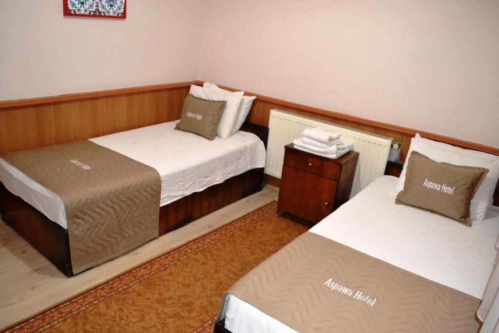 Giường trong phòng chung tại Aspawa Hotel