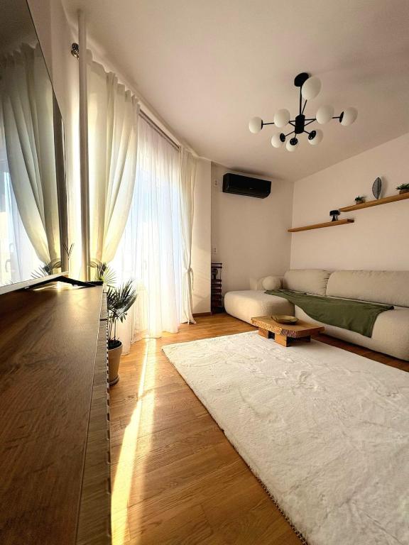 a living room with a bed and a large window at ParkView in Craiova