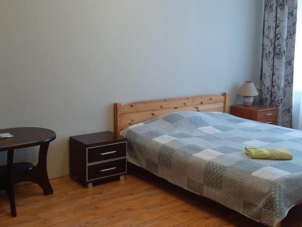 a bedroom with a bed and a desk and a table at Korter in Narva