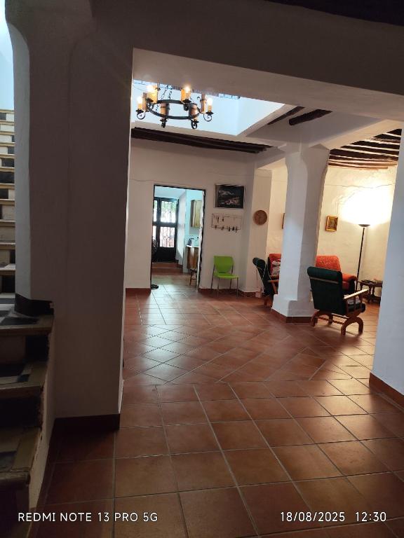 a living room with a tile floor and a hallway at Gustavo's Old House in Fiñana