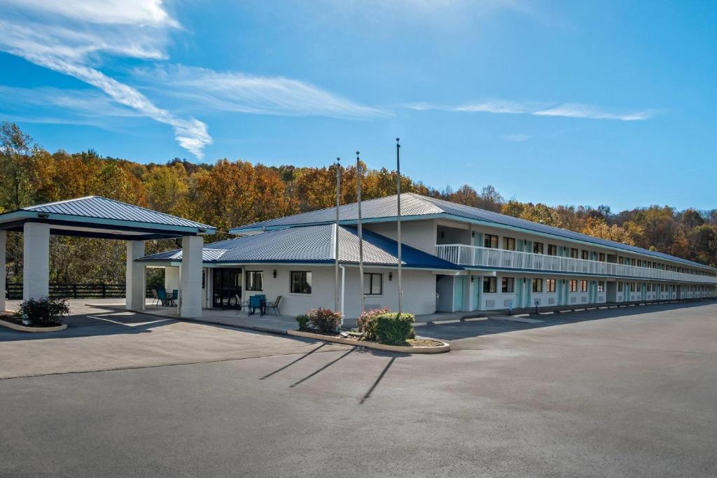 a large white building with a parking lot at Days Inn by Wyndham Renfro Valley Mount Vernon in Mount Vernon