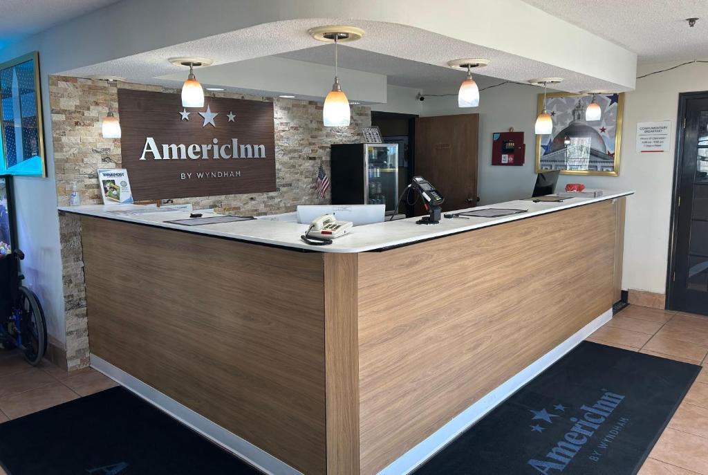 a reception counter at an american firm restaurant at AmericInn by Wyndham Mosinee Central Wisconsin Airport in Mosinee