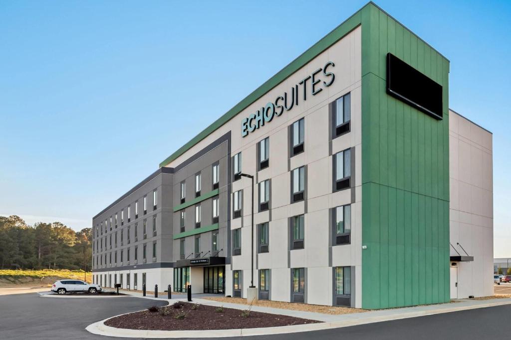 a large building with a green and white facade at Echo Suites Extended Stay by Wyndham Atlanta-Conyers in Conyers